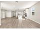 Spacious living area with wood-look tile flooring, an open layout, and a modern kitchen at 17749 W Elm St, Goodyear, AZ 85395