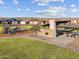 Community recreation area including a covered pavilion with picnic tables, a playground, and lush landscaping at 17749 W Elm St, Goodyear, AZ 85395