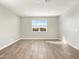Neutral room with wood-look tile flooring, offering a versatile space for various uses at 17749 W Elm St, Goodyear, AZ 85395