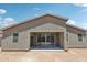 Exterior of new home with patio; backyard is ready for landscaping at 47267 W Mellen Ln, Maricopa, AZ 85139