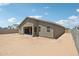 Image of home's backyard area showing the block fence, patio and natural landscaping potential at 47267 W Mellen Ln, Maricopa, AZ 85139
