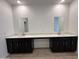 Bathroom features a large double vanity with mirrors and modern lighting at 47267 W Mellen Ln, Maricopa, AZ 85139