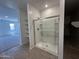 Bathroom includes a glass-enclosed shower and built-in shelving, for all of your storage needs at 47267 W Mellen Ln, Maricopa, AZ 85139