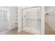 Bathroom features a glass-enclosed shower with built-in shelving and tile flooring at 47267 W Mellen Ln, Maricopa, AZ 85139