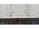 Elegant bathroom featuring double sinks, quartz countertops, and dark wood cabinets at 47267 W Mellen Ln, Maricopa, AZ 85139