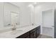 Stylish bathroom with a double sink vanity, quartz countertop, and dark wood cabinets at 47267 W Mellen Ln, Maricopa, AZ 85139