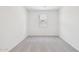 Empty bedroom shows a carpeted floor and a window letting in natural light at 47267 W Mellen Ln, Maricopa, AZ 85139