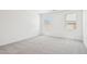 Bright bedroom with neutral carpet and two windows providing natural light at 47267 W Mellen Ln, Maricopa, AZ 85139