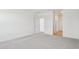 Bright bedroom with neutral carpet and two doorways for convenient access at 47267 W Mellen Ln, Maricopa, AZ 85139