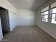 Well-lit bedroom featuring plush carpeting, a window with natural light, and a spacious closet at 47267 W Mellen Ln, Maricopa, AZ 85139