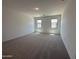 Spacious bedroom features plush carpeting and two windows providing ample natural light at 47267 W Mellen Ln, Maricopa, AZ 85139