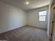 Neutral bedroom with soft carpeting, a window for natural light, and a cozy, inviting feel at 47267 W Mellen Ln, Maricopa, AZ 85139