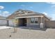 A single-story home showcases desert landscaping, complementing its neutral-toned exterior at 47267 W Mellen Ln, Maricopa, AZ 85139