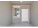 Covered porch featuring a white front door and a window to the left at 47267 W Mellen Ln, Maricopa, AZ 85139