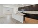 Modern kitchen boasts dark cabinets, stainless steel appliances, and a large island with a sink at 47267 W Mellen Ln, Maricopa, AZ 85139