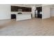 Bright kitchen featuring dark cabinets, stainless steel appliances, and a center island at 47267 W Mellen Ln, Maricopa, AZ 85139