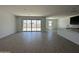 The living room features tile flooring, a large sliding glass door, and is adjacent to the kitchen at 47267 W Mellen Ln, Maricopa, AZ 85139
