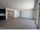 The living room features tile flooring, a large sliding glass door, and is adjacent to the kitchen at 47267 W Mellen Ln, Maricopa, AZ 85139