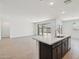 Bright, open-concept living area features wood-look tile flooring and sliding glass doors to the backyard at 47267 W Mellen Ln, Maricopa, AZ 85139