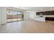 Open floor plan featuring a living area with kitchen access and large sliding glass doors at 47267 W Mellen Ln, Maricopa, AZ 85139