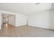 Spacious and bright living area featuring wood-look tile floors and neutral paint at 47267 W Mellen Ln, Maricopa, AZ 85139