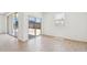 A bright living space offers sliding glass doors and wood-look tile floors at 47267 W Mellen Ln, Maricopa, AZ 85139