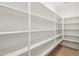 Spacious pantry featuring ample shelving and hardwood flooring at 47267 W Mellen Ln, Maricopa, AZ 85139