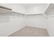 Walk-in closet featuring neutral carpet and metal shelving at 47267 W Mellen Ln, Maricopa, AZ 85139