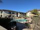 Community pool with lounge chairs and patio umbrellas at 6900 E Princess Dr # 1219, Phoenix, AZ 85054