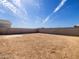 Large, unfinished backyard with privacy wall, offering ample space for landscaping at 9120 N 174Th Ln, Waddell, AZ 85355