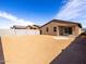 Expansive, unfinished backyard with block wall and covered patio, ready for customization at 9120 N 174Th Ln, Waddell, AZ 85355