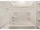 Bright, all-white bathroom featuring a shower-tub combo with recessed shelving at 9120 N 174Th Ln, Waddell, AZ 85355