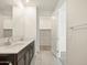 Contemporary bathroom featuring a double sink vanity and access to a walk-in closet at 9120 N 174Th Ln, Waddell, AZ 85355