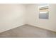 Bright, carpeted bedroom with a window at 9120 N 174Th Ln, Waddell, AZ 85355