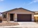 Charming single-story home with desert landscaping, stone accents, and a two-car garage at 9120 N 174Th Ln, Waddell, AZ 85355