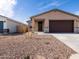 Single-story home with desert landscaping, stone accents, and a two-car garage at 9120 N 174Th Ln, Waddell, AZ 85355