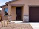 Close-up of the front entrance with stone accents and desert landscaping at 9120 N 174Th Ln, Waddell, AZ 85355