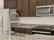 Modern kitchen featuring stainless steel appliances, granite countertops, and a modern faucet at 9120 N 174Th Ln, Waddell, AZ 85355