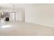 Bright living room with modern light fixtures, tile flooring, and an open concept layout to the kitchen at 9120 N 174Th Ln, Waddell, AZ 85355