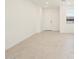 Bright living room with tile flooring, neutral paint colors, and an entrance to the home at 9120 N 174Th Ln, Waddell, AZ 85355