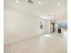 Bright living room with modern light fixtures, tile flooring, and an open concept layout to the kitchen at 9120 N 174Th Ln, Waddell, AZ 85355