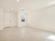 Bright living room with tile flooring, neutral paint colors, and an entrance to the home at 9120 N 174Th Ln, Waddell, AZ 85355