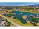 Scenic aerial view of the community with a lake, golf course, pools, and mountain views at 11899 N Spearfish St, Surprise, AZ 85388