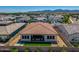 Aerial view of private backyard featuring manicured lawn, desert landscaping, privacy fence, and outdoor seating at 11899 N Spearfish St, Surprise, AZ 85388