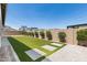 Beautiful backyard featuring well-maintained artificial grass and elegant paver stone accents at 11899 N Spearfish St, Surprise, AZ 85388