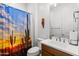 Bathroom featuring a sink, toilet, and a shower with a cactus-themed shower curtain at 11899 N Spearfish St, Surprise, AZ 85388