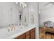 Bathroom with double sinks, white countertops, and wood cabinets at 11899 N Spearfish St, Surprise, AZ 85388
