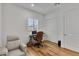 Neutral office space features light walls, wood floors, a brown chair and a white recliner at 11899 N Spearfish St, Surprise, AZ 85388