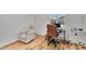 Neutral office space features light walls, wood floors, a brown chair and a white recliner at 11899 N Spearfish St, Surprise, AZ 85388
