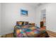 Bedroom featuring neutral walls, hardwood floors, a bed with colorful quilt, and a nightstand at 11899 N Spearfish St, Surprise, AZ 85388